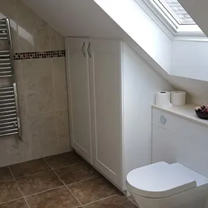 a bathroom with a toilet and a radiator